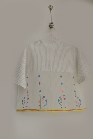 Spring Bloom Top ensemble by INDIGO DREAMS featuring floral-patterned blouse with ruffled details and pastel colors.